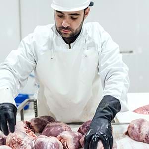 bhj-employee-inspects-raw-animal-hearts-image