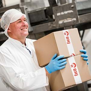 bhj-employee-carries-two-boxes-of-packaged-products-image