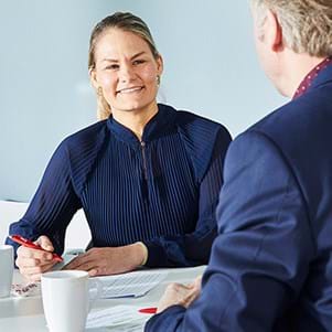 two-bhj-employees-sitting-at-a-table-image